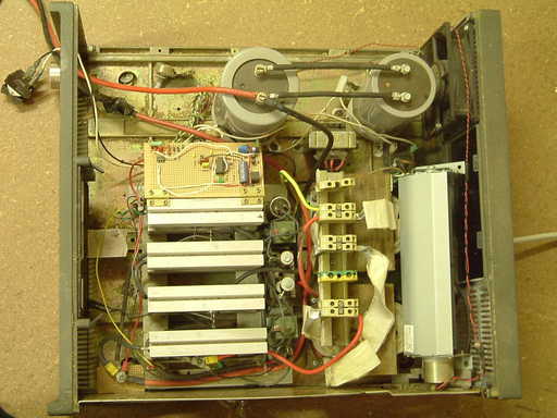 [Internal view of welder. The four rectifier heatsinks  are at bottom left. The two transformers are to the right. The capacitors at the top are not currently in circuit.]